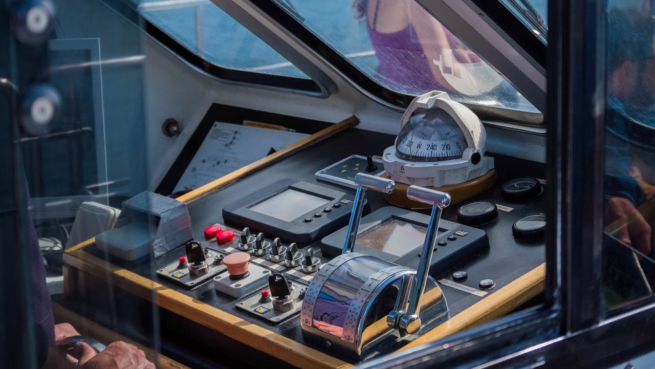Close-up view of a ship's control console with navigational equipment, showcasing maritime technology.